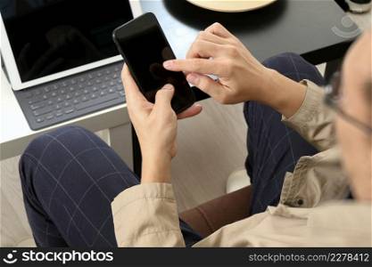 hand using smart phone and digital tablet computer for online banking payment communication in modern office