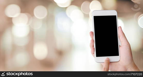 Hand using smart phone with blank screen over blur bokeh light background, business and technology, internet of things concept