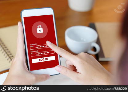 Hand using smart phone with password login at office desk background, cyber security concept