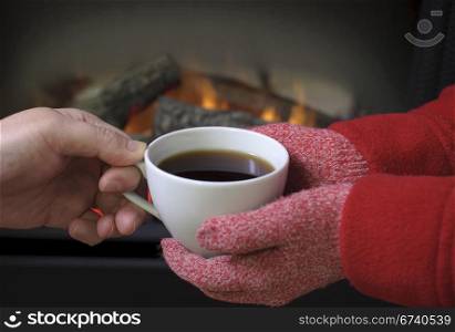 Hand warming at a fireplace