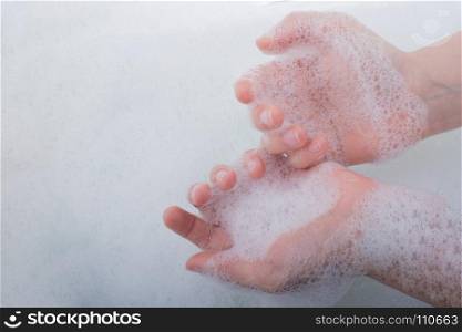 Hand washing and soap foam on a foamy background