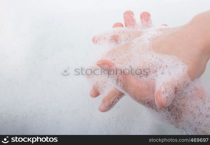 Hand washing and soap foam on a foamy background