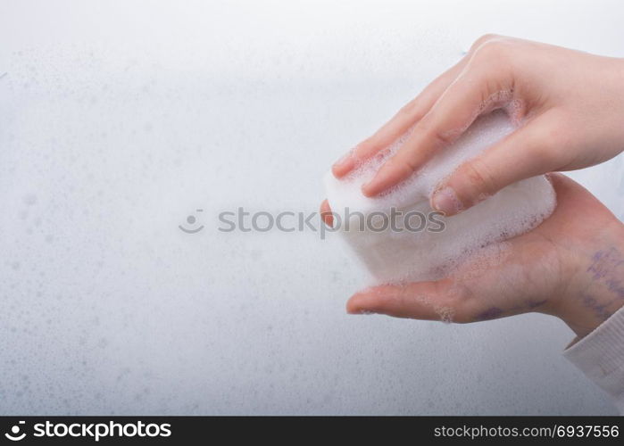 Hand washing and soap foam on a foamy background