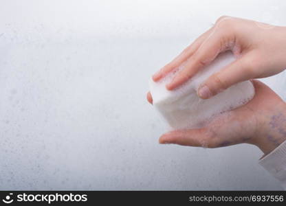 Hand washing and soap foam on a foamy background