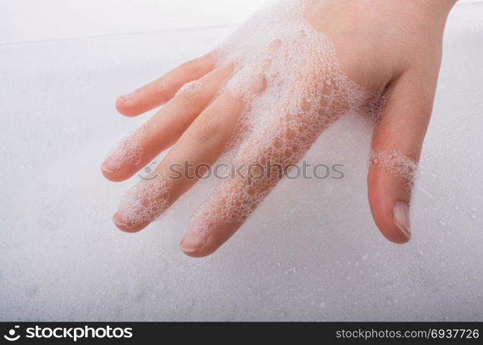 Hand washing and soap foam on a foamy background