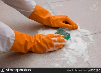 hand washing floor by cleaning sponge with foam