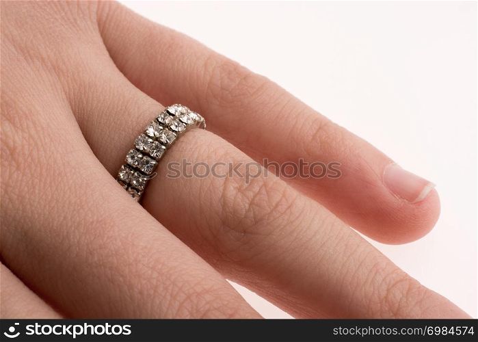 Hand wearing a ring on a white background