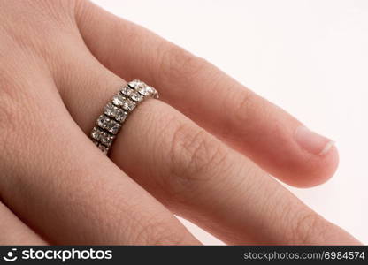 Hand wearing a ring on a white background