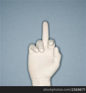 Hand wearing white rubber glove with middle finger extended making profane gesture.