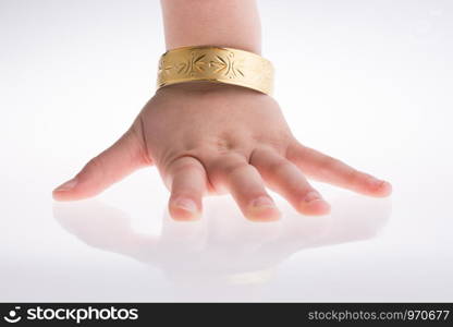 Hand with a golden bracelet on a white background