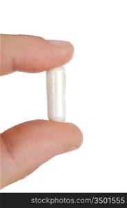 hand with a pill over a white background