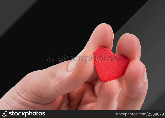 Hand with a red heart on a white background