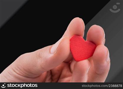 Hand with a red heart on a white background