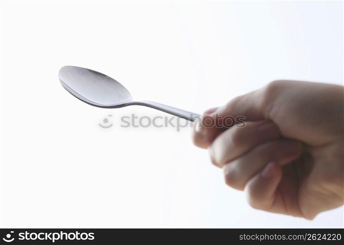 Hand with a spoon