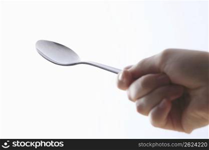 Hand with a spoon