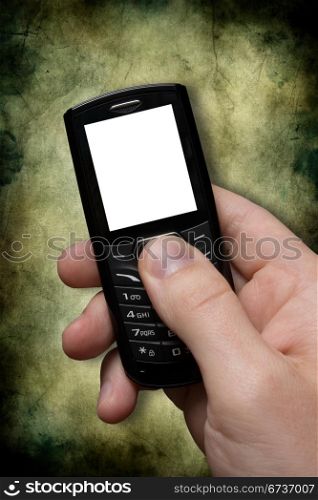 hand with black mobile phone on dark background