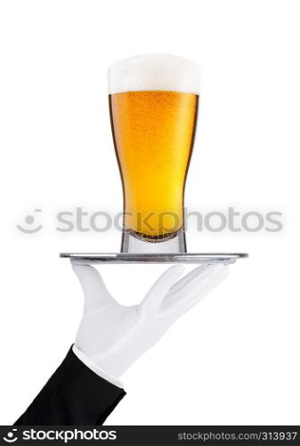 Hand with glove holds tray with lager beer glass with foam and dew isolated on white background