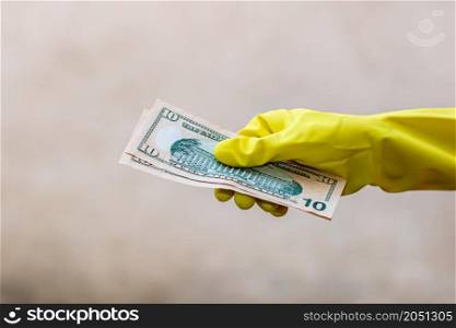 Hand with gloves receiving, giving or holding USD EURO banknote. World money concept