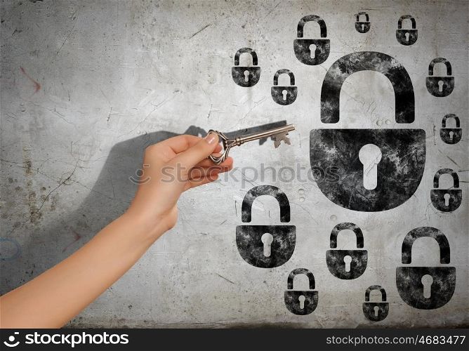 Hand with key. Close up image of human hand inserting key in key hole