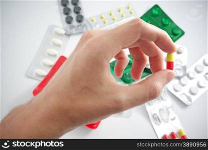 Hand with pill. Element of medical design.