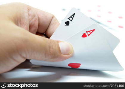 Hand with poker cards isolated on white background