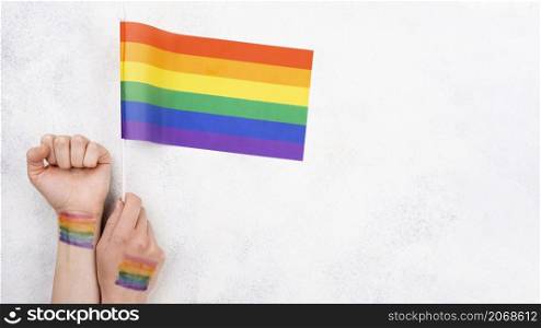 hand with rainbow flag paint