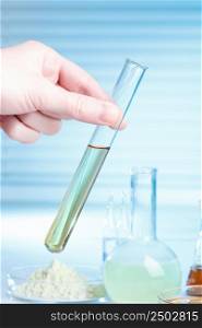 Hand with test tube in laboratory, medical or chemical research concept