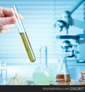 Hand with test tube in laboratory, medical or chemical research concept