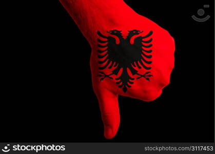 Hand with thumb down gesture in colored albania national flag as symbol of negative political, cultural, social management of country