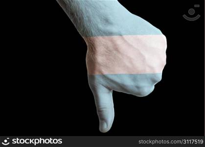 Hand with thumb down gesture in colored argentina national flag as symbol of negative political, cultural, social management of country