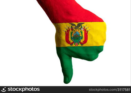 Hand with thumb down gesture in colored bolivia national flag as symbol of negative political, cultural, social management of country