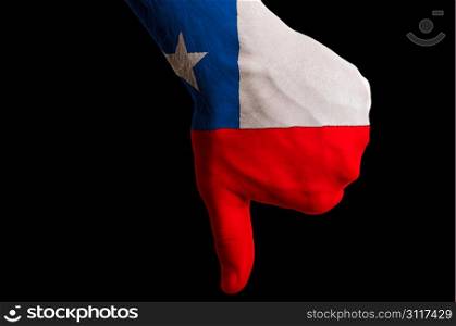 Hand with thumb down gesture in colored chile national flag as symbol of negative political, cultural, social management of country