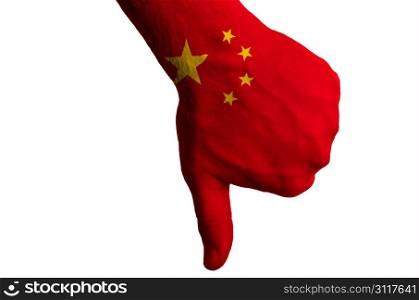Hand with thumb down gesture in colored china national flag as symbol of negative political, cultural, social management of country