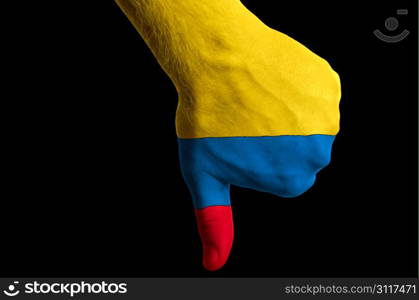Hand with thumb down gesture in colored colombia national flag as symbol of negative political, cultural, social management of country