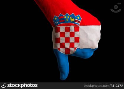 Hand with thumb down gesture in colored croatia national flag as symbol of negative political, cultural, social management of country