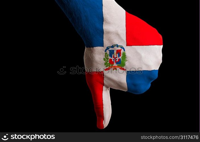 Hand with thumb down gesture in colored dominican national flag as symbol of negative political, cultural, social management of country