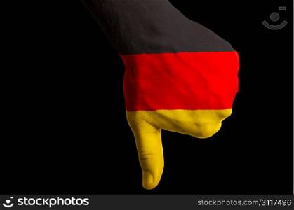 Hand with thumb down gesture in colored germany national flag as symbol of negative political, cultural, social management of country