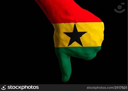 Hand with thumb down gesture in colored ghana national flag as symbol of negative political, cultural, social management of country