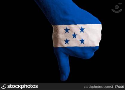 Hand with thumb down gesture in colored honduras national flag as symbol of negative political, cultural, social management of country