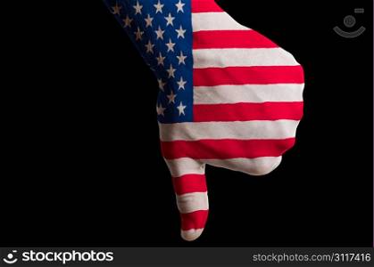 Hand with thumb down gesture in colored us national flag as symbol of negative political, cultural, social management of country