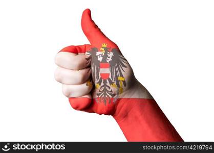 Hand with thumb up gesture colored in austria national flag as symbol of excellence, achievement, good, - useful for tourism and touristic advertising and also current positive political, cultural, social management of state or country