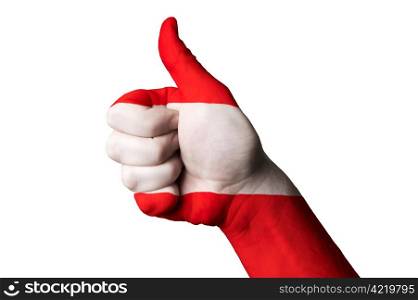 Hand with thumb up gesture colored in austria national flag as symbol of excellence, achievement, good, - useful for tourism and touristic advertising and also current positive political, cultural, social management of state or country
