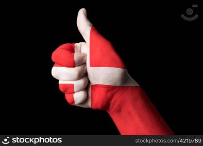 Hand with thumb up gesture colored in denmark national flag as symbol of excellence, achievement, good, - useful for tourism and touristic advertising and also current positive political, cultural, social management of state or country