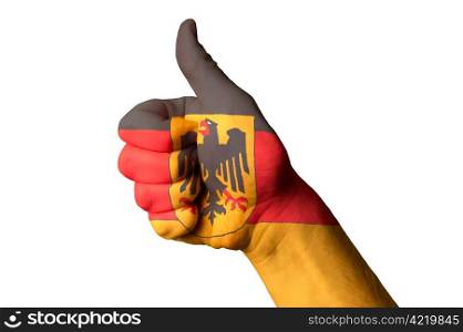 Hand with thumb up gesture colored in germany national flag as symbol of excellence, achievement, good, - useful for tourism and touristic advertising and also current positive political, cultural, social management of state or country