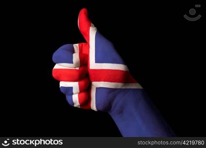 Hand with thumb up gesture colored in iceland national flag as symbol of excellence, achievement, good, - useful for tourism and touristic advertising and also current positive political, cultural, social management of state or country