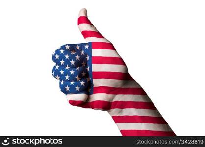 Hand with thumb up gesture in colored america national flag as symbol of excellence, achievement, good, - for tourism and touristic advertising, positive political, cultural, social management of country