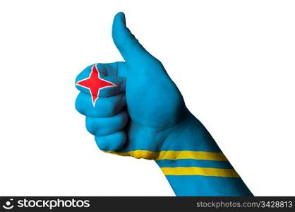 Hand with thumb up gesture in colored aruba national flag as symbol of excellence, achievement, good, - for tourism and touristic advertising, positive political, cultural, social management of country