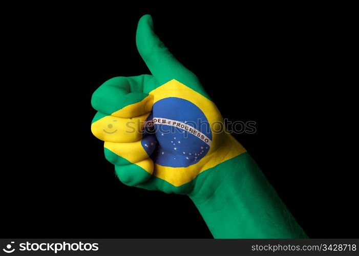 Hand with thumb up gesture in colored brazil national flag as symbol of excellence, achievement, good, - for tourism and touristic advertising, positive political, cultural, social management of country
