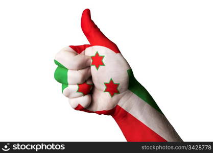 Hand with thumb up gesture in colored burundi national flag as symbol of excellence, achievement, good, - for tourism and touristic advertising, positive political, cultural, social management of country