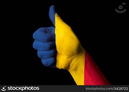 Hand with thumb up gesture in colored chad national flag as symbol of excellence, achievement, good, - for tourism and touristic advertising, positive political, cultural, social management of country